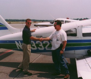 Instructor Tim Napier congratulating me after my first solo flight, July 20, 1998.